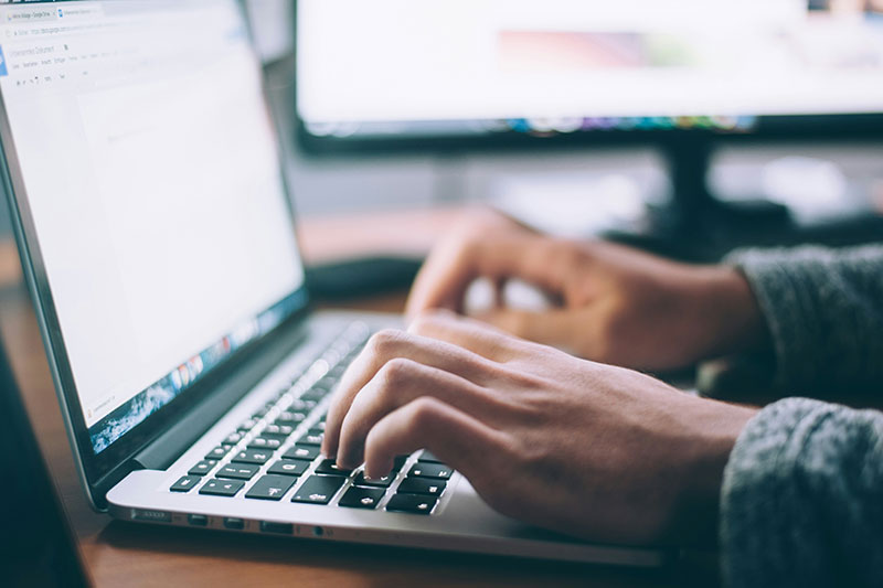 Person typing on laptop